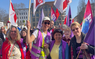 Eine Gruppe Frauen mit NGG-Fahnen auf der Demonstration zum Frauentag in Berlin 2025. 